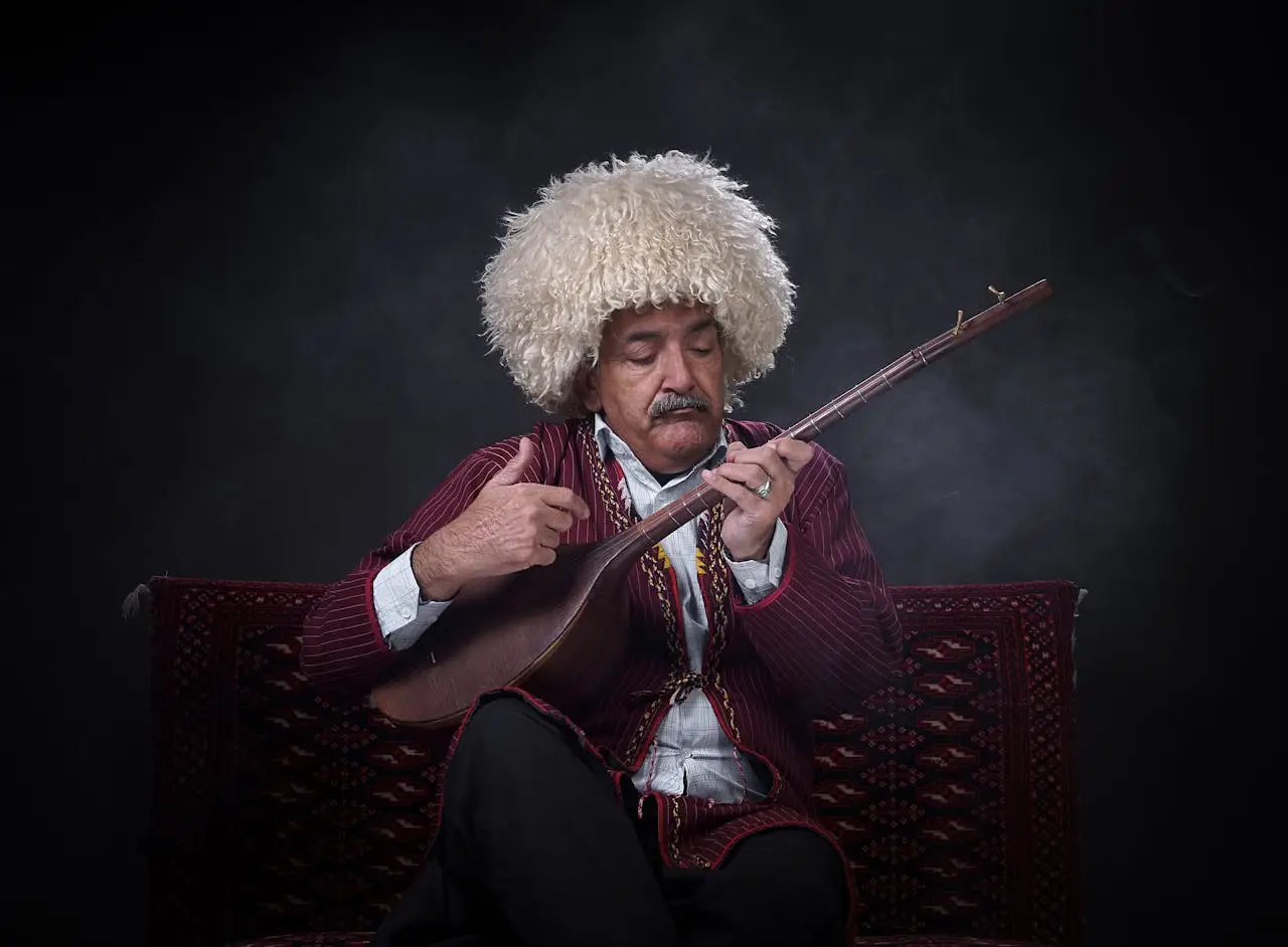 Elderly Persian musician in traditional attire playing a rud indoors.
