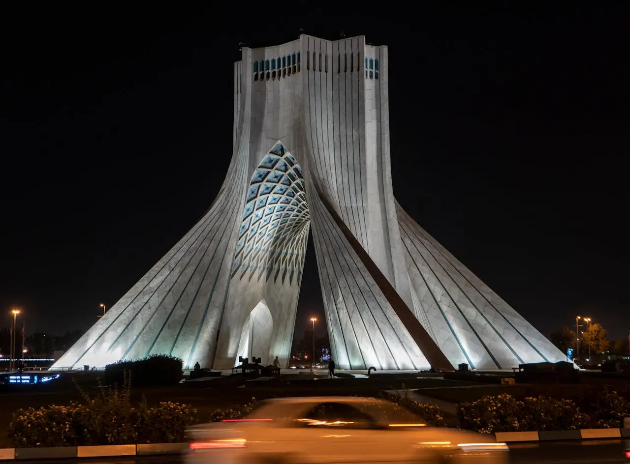 Azadi Tower brightly illuminated at night in Tehran, a notable symbol of Irans modern architecture.