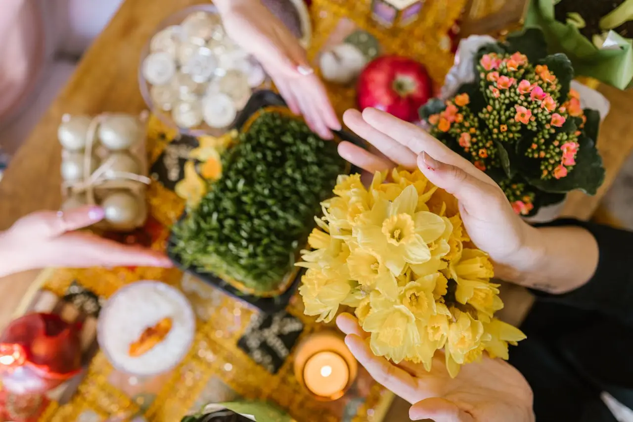 A vibrant display of the Haft Sin table during Nowruz, featuring flowers and traditional items.