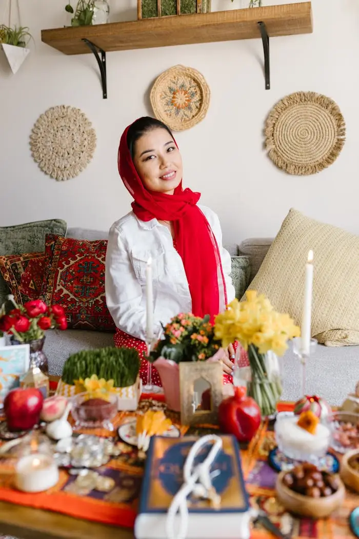 A woman celebrates Nowruz with a traditional Haft Sin setup, symbolizing Persian New Year.